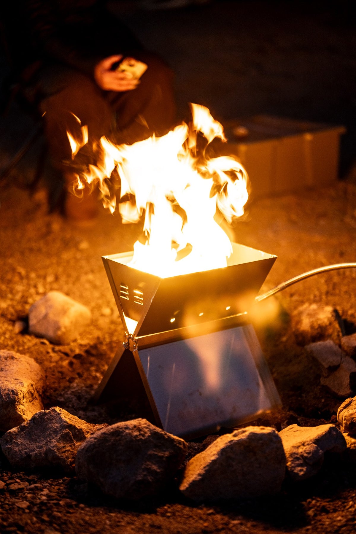 The FireFold burning at full flame at a night camp